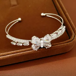 Detailed view of an elegant silver cuff bracelet with a sparkling zirconia butterfly