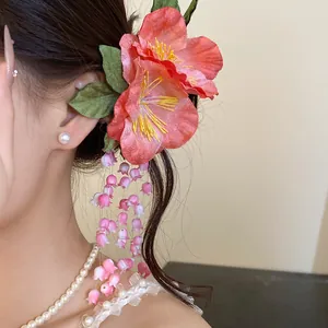 Elegant handmade pink fabric flower hair clip with long tassel fringe for wedding hairstyles