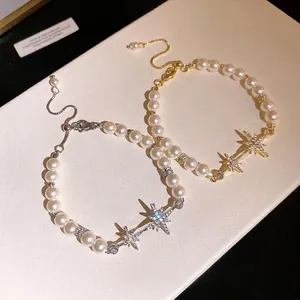 Elegant 18K gold plated pearl bracelet featuring a dazzling star pendant.