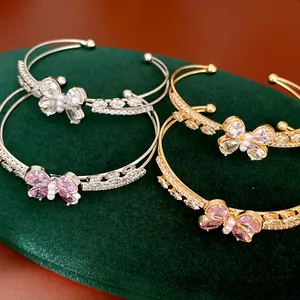 Close-up of elegant double-layer butterfly bangles with pink and clear zircons