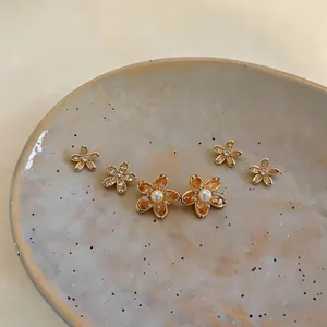 Detail shot of golden zirconia starfish earring set with pearl centers on a plate