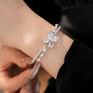 Close-up of a silver-toned double-layered bangle with a sparkling zircon butterfly motif