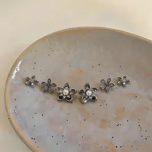 Elegant set of six silver flower stud earrings with sparkling zircon and pearl centers