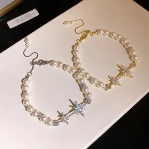 Detailed macro shot of gold and silver plated starburst pearl bracelets with zircon accents