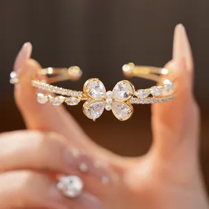 Close-up of double-layer butterfly bangle with sparkling cubic zirconia and pearls