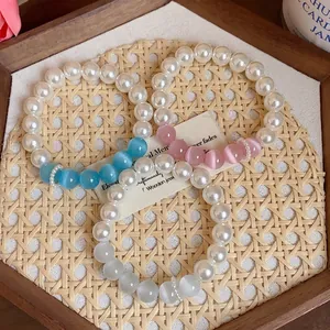 Elegant pearl bracelet set with colorful cat's eye beads for a sweet and trendy look.