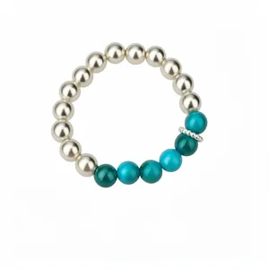 Elegant pearl bracelet featuring vibrant blue and teal accent beads on white background.