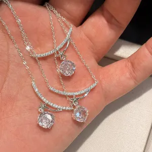 Close-up of sparkling flower-cut zircon necklace with star pendant and silver chain.