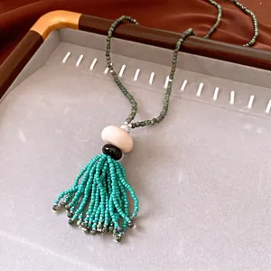 Handmade ethnic green beaded necklace with tassel and resin accents