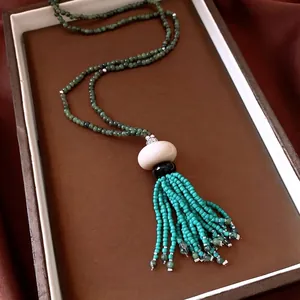 Vintage ethnic style beaded tassel necklace with turquoise accents and resin beads