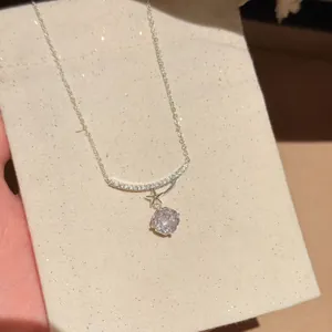 Close-up detail of a sparkling flower pendant necklace with high-grade cubic zirconia stones