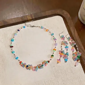 Close-up of vibrant dopamine style resin flower and stone beaded necklace and earrings set