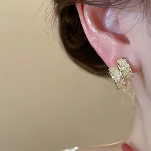 Detailed view of 14k gold plated hoop earrings featuring shimmering glass crystal stones