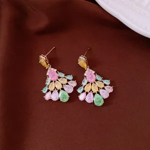 Macro detail of multi-colored teardrop zircon earrings with vintage 14k gold plating finish