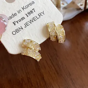 Close-up detail of 14k gold plated stud earrings with exquisite sparkling glass stone texture