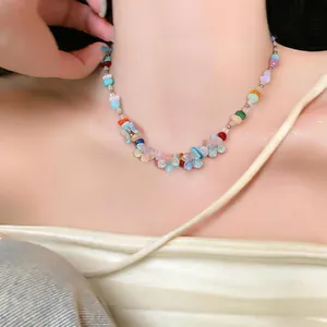 Close-up shot of a colorful resin flower beaded necklace worn by a model in dopamine style