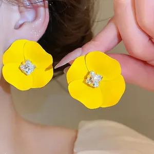Vibrant yellow flower stud earrings with center crystal for summer vacation style