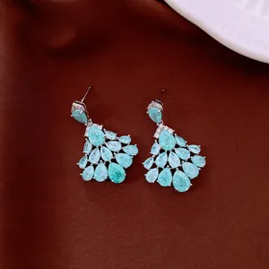 Detail view of luxury vintage teardrop earrings with light blue zircon stones in silver.
