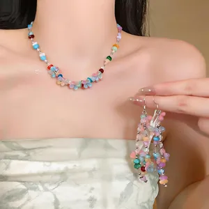 Close-up of colorful resin flower beaded necklace and matching fringe earrings set