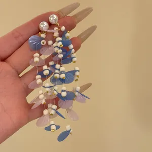Elegant long resort style tassel earrings with white pearls and blue pink translucent floral petals