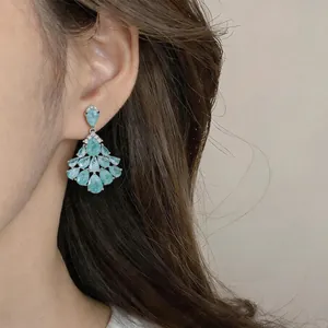 Close-up of vintage style 14k gold plated chandelier earrings with light blue zircons