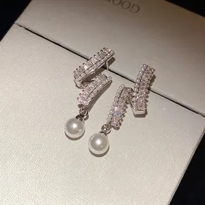 Silver needle zircon encrusted earrings with dangling pearls in a stylish design