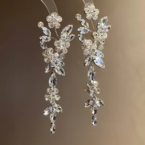 Elegant silver-toned floral tassel earrings featuring intricate sparkling rhinestone clusters