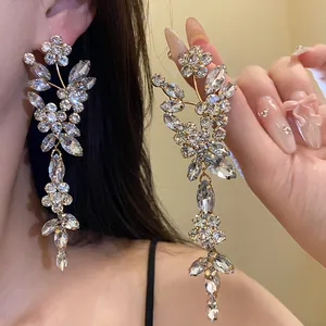 Close-up of silver needle rhinestone floral tassel earrings with elegant sparkling crystals.