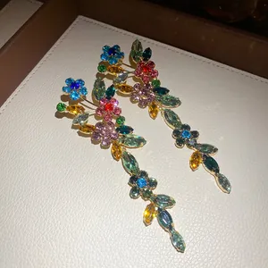 Detailed view of colorful crystal flower tassel earrings with sparkling rhinestones