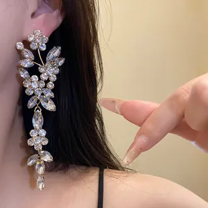 Exquisite long sparkling crystal flower tassel earrings shown as detail on model's ear