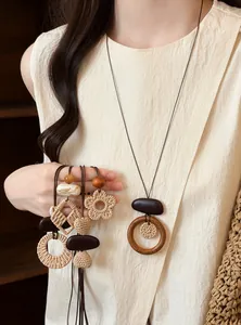 Detailed view of handmade bohemian woven necklaces with wooden beads and rattan flower charms
