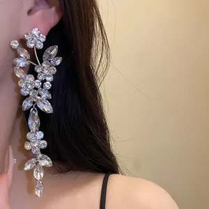 Macro view of sparkling rhinestone flower tassel drop earrings showing exquisite detail.