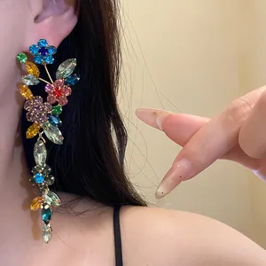 Detailed view of vibrant multicolor floral rhinestone tassel earrings worn by an Asian model
