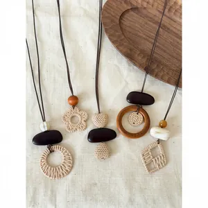 Bohemian handmade woven necklaces with unique geometric pendants shown on linen backdrop