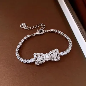 Vintage refined silver tennis bracelet with a sparkling zirconia bow and pearl center