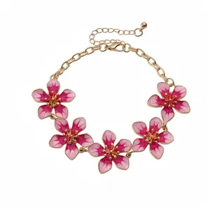 Elegant gold plated chain bracelet featuring five gradient pink enamel flower charms