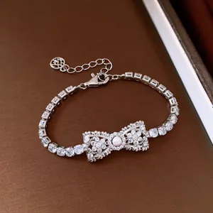 Close-up of elegant cubic zirconia bow bracelet featuring a luminous central pearl ornament