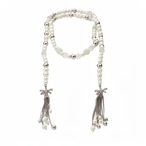 Elegant extra-long faux pearl necklace featuring rhinestone bows and metallic tassels