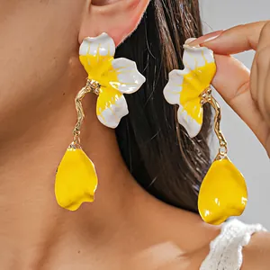 Detailed view of enamel flower earrings with vibrant yellow and white petals for women