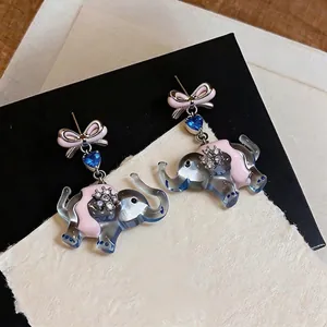 Cute elephant drop earrings featuring pink bows and shimmering blue heart zircon.
