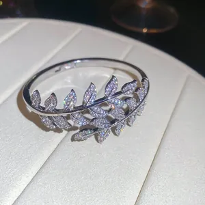 Detailed macro view of a silver-toned zircon leaf bangle with sparkling pave stones