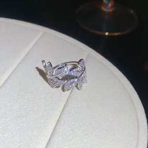 Detailed macro shot of an elegant zircon leaf ring featuring sparkling stones on a display.