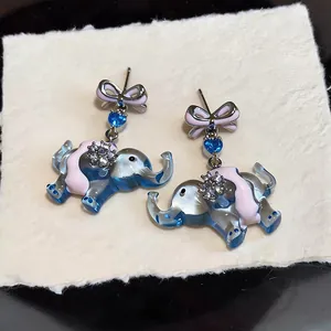 Detailed view of cute blue elephant stud earrings with pink bows and sparkling zircons.