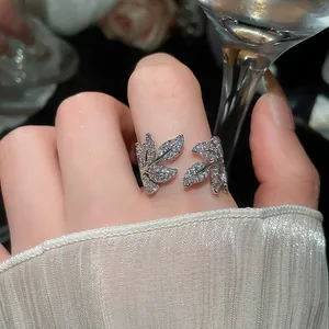 Detailed macro view of silver leaf ring with pavé-set sparkling cubic zirconia stones