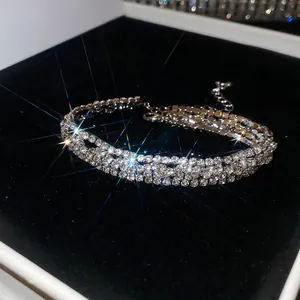 Primer plano de una pulsera brillante de tres capas con pedrería sobre terciopelo