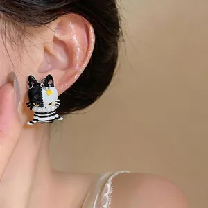 Asymmetric black and white enamel cat stud earrings with elegant pearls and star