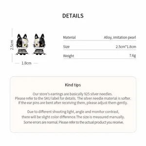 Detailed view of asymmetrical cat pearl earrings with size and material specifications