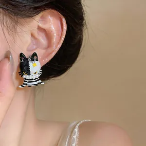 Creative asymmetric black and white cat stud earrings with pearl and star details for women