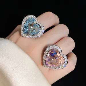 Detail view of two elegant heart-shaped cubic zirconia rings in light blue and soft pink