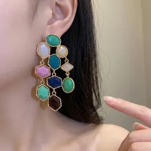 Vintage multi-colored resin tassel earrings with geometric shapes shown on an Asian model